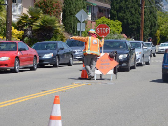 worker holding a stop sign and directing traffic