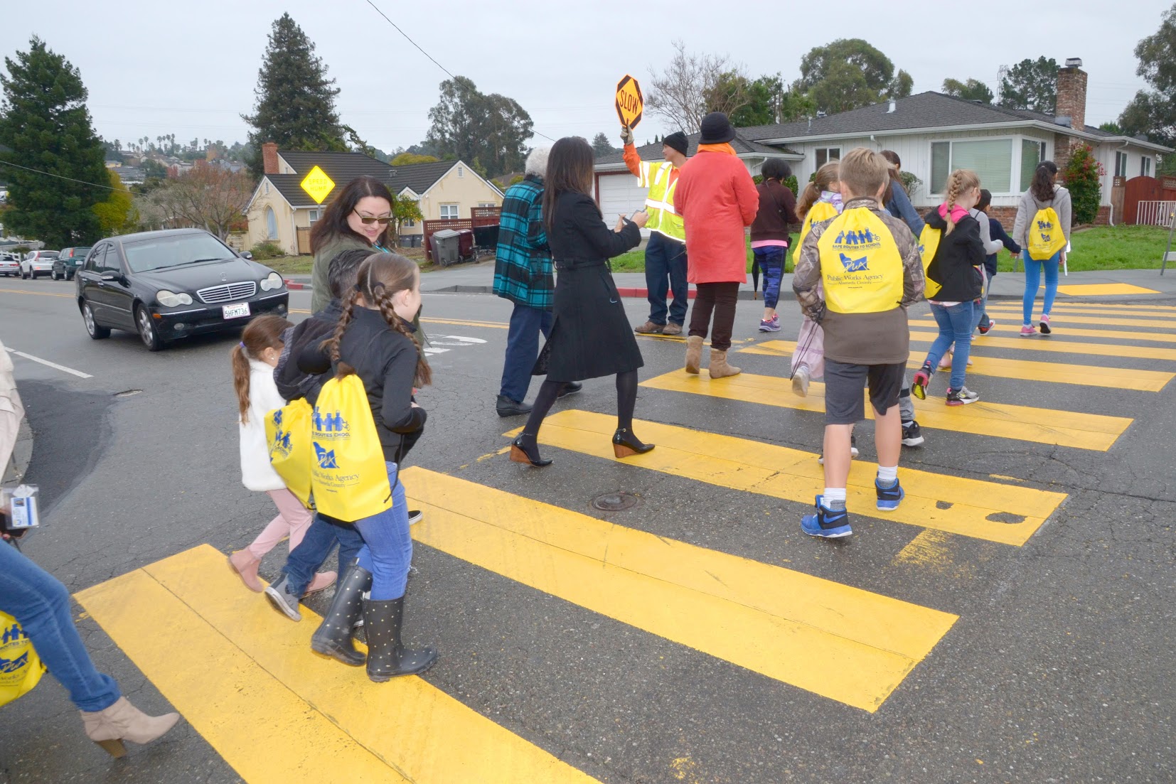 crossing guard helping students across a street