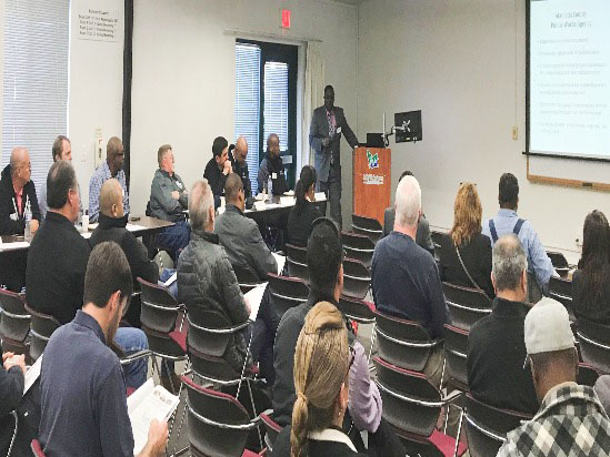 people in meeting listening to speaker giving presentation