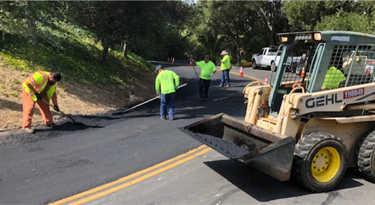a group of workers doing road maintenance