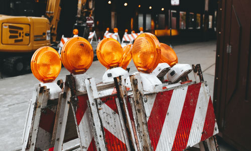 set of a-frame road closure barricades with orange lights